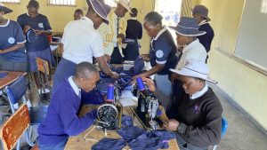 Mrs Ndaneta Chivaviro (center), Tuseme Teacher, Seke Mhuriimwe Secondary, facilitating a training session onre-usable sanitary pads one of the initiatives Seke Mhuriimwe Secondary Tuseme club is undertaking to combat SRGBV and Period poverty